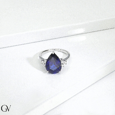 Ring in white gold 18k with central blue sapphire drop cut and three diamonds per side