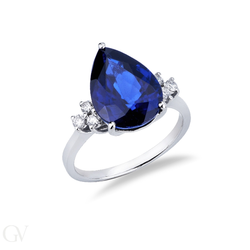 Ring in white gold 18k with central blue sapphire drop cut and three diamonds per side