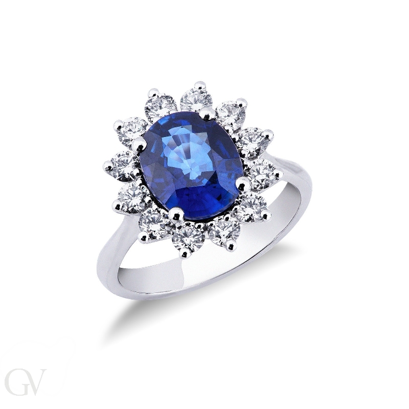 White gold 18k ring with twelve halo diamonds and a central blue sapphire