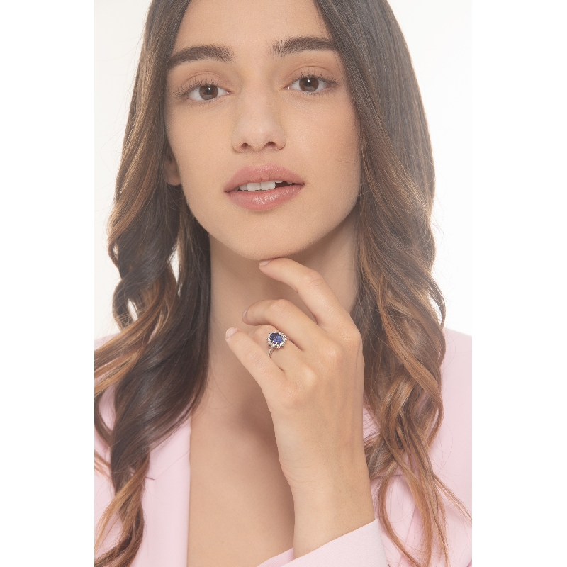 18k white gold halo ring with an oval tanzanite and diamonds