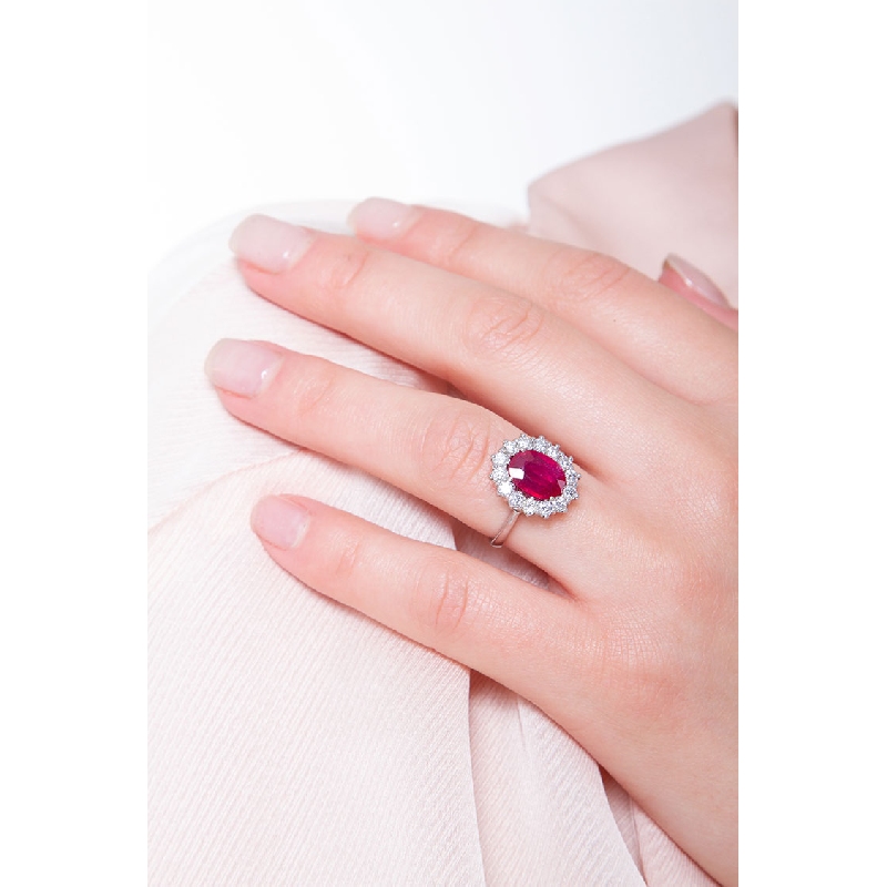 Halo ring with central ruby oval cut and diamonds white gold 18k