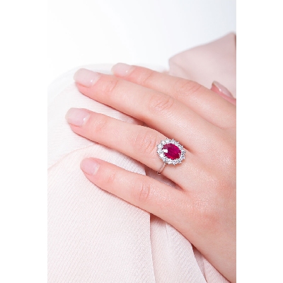 Halo ring with central ruby oval cut and diamonds white gold 18k