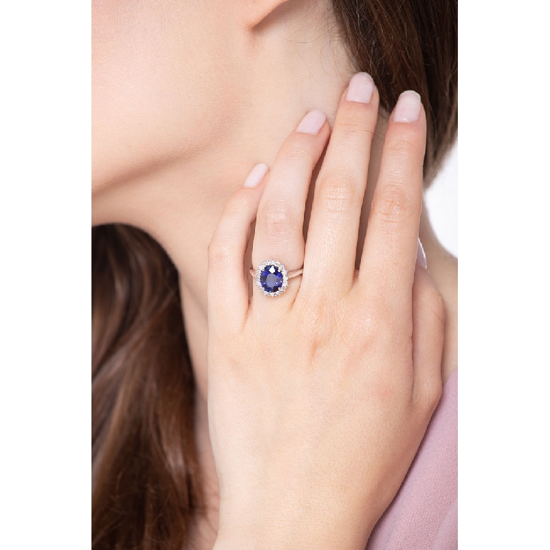White gold 18k halo ring with a central blue sapphire and diamonds 