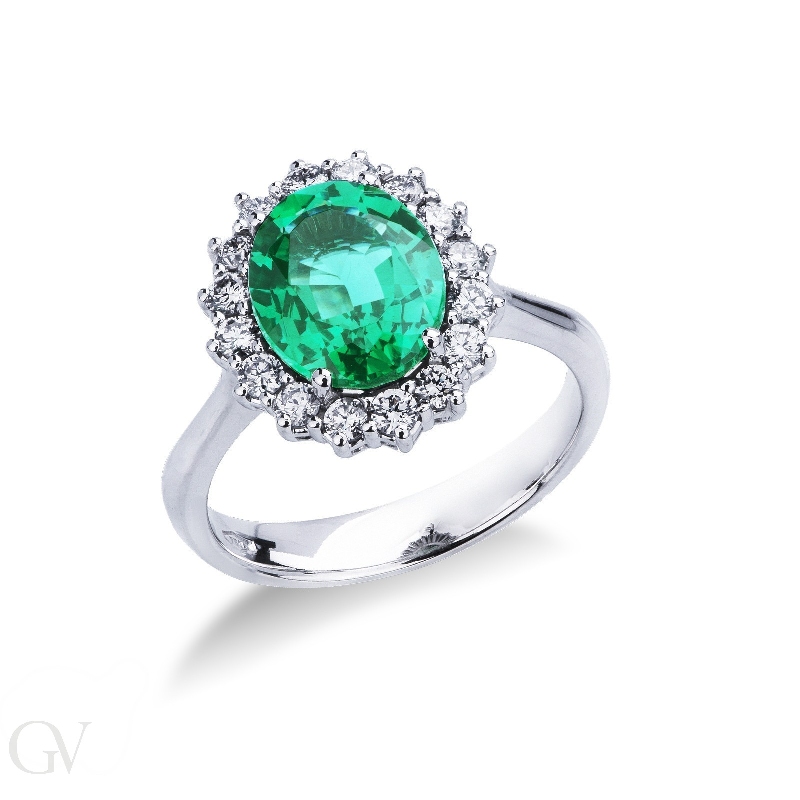 Halo ring with oval cut central emerald and diamonds in white gold 18k