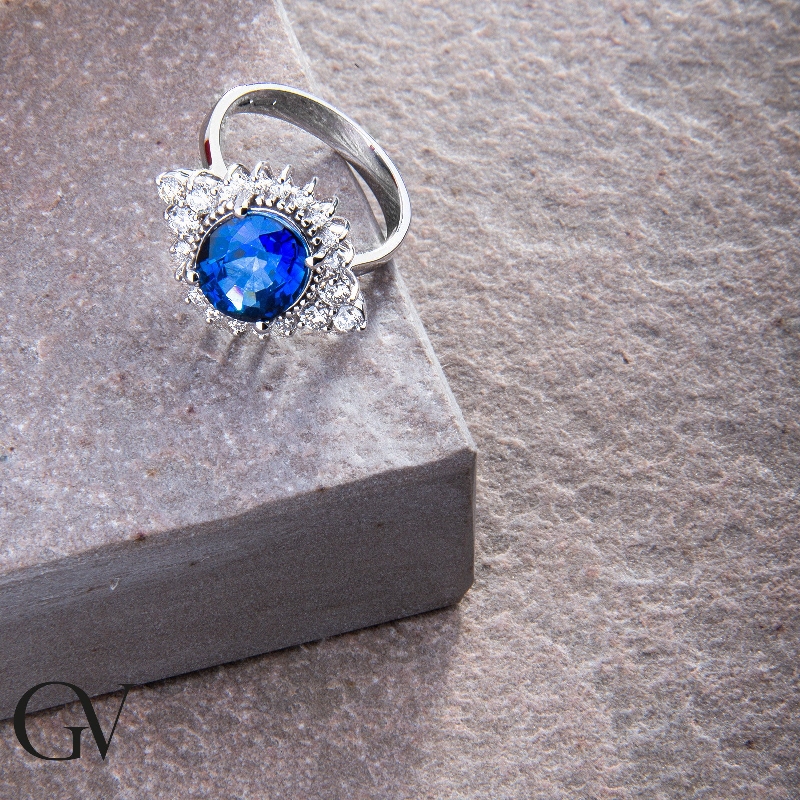 White gold 18k ring with diamonds and an oval cut blue sapphire