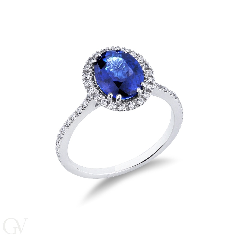 18k white gold halo ring with blue oval sapphire and diamond shoulder set 