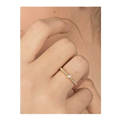 Yellow gold 18k ring with central bezel diamond and diamonds shoulder set 