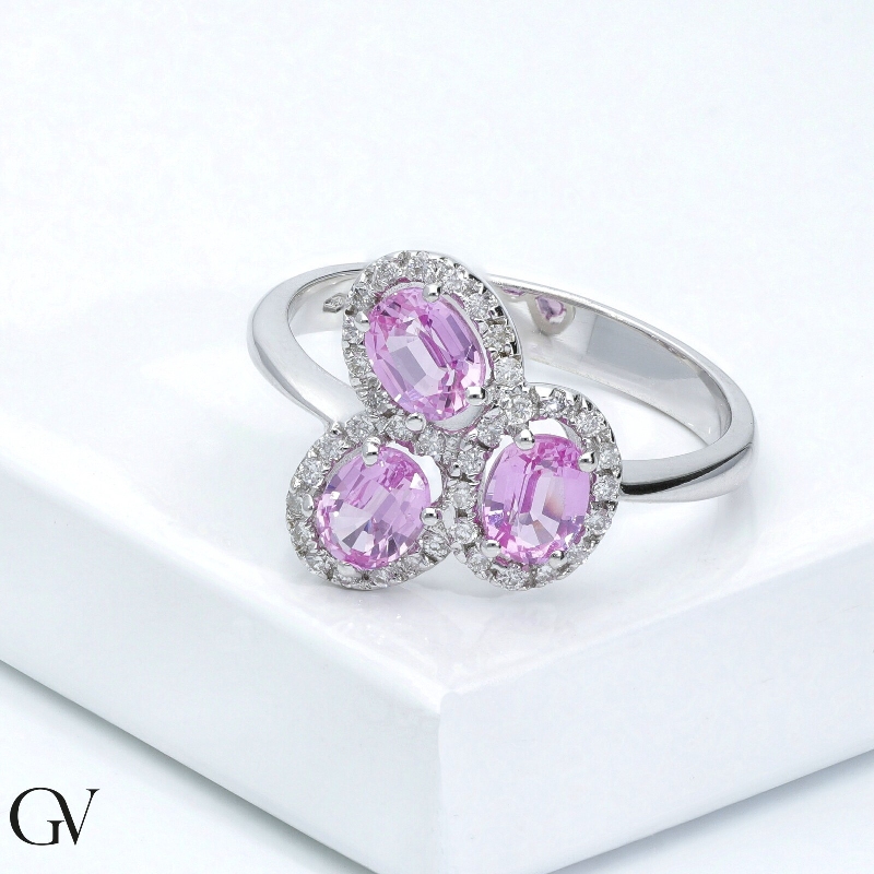 18k white gold halo ring with diamonds and three oval cut pink sapphires