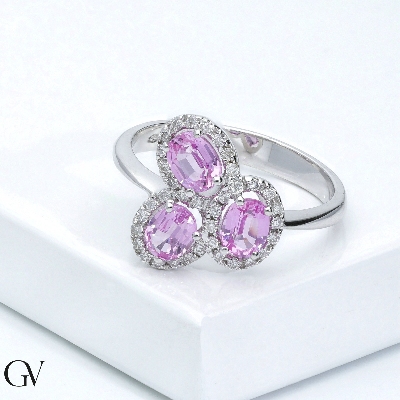 18k white gold halo ring with diamonds and three oval cut pink sapphires