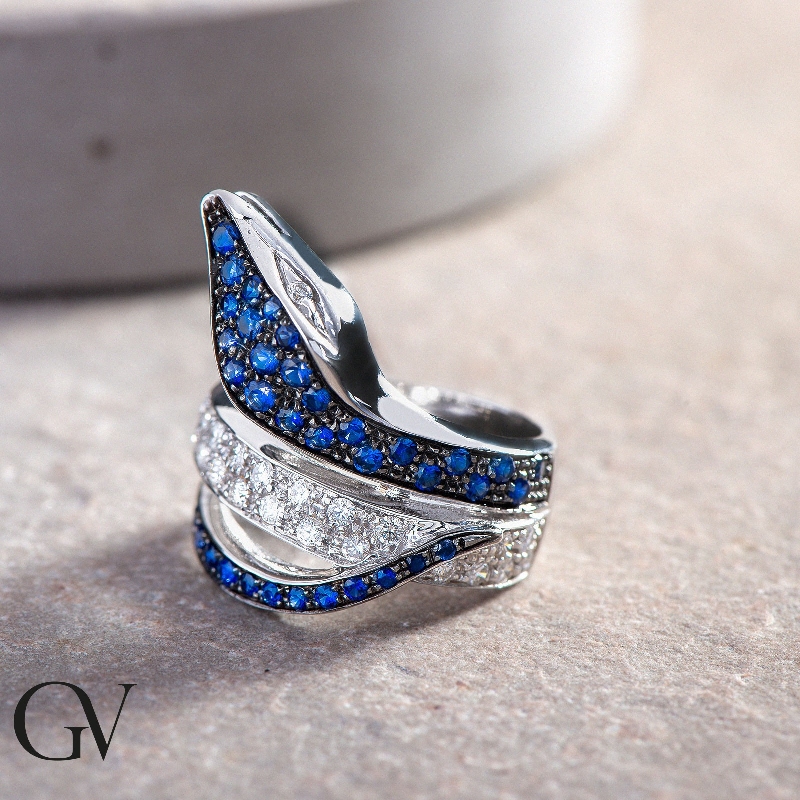 White gold 18k snake ring with diamonds and blue sapphires on head and tail