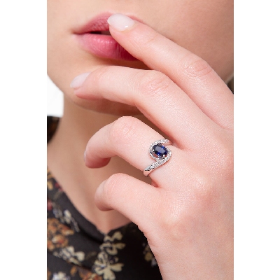 18k white gold ring with a central blue sapphire oval cut and diamonds 