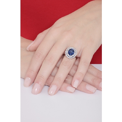 Halo ring with a central blue sapphire and diamonds white gold 18k