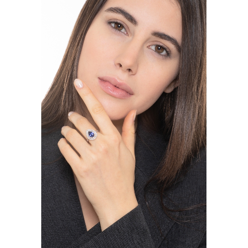 White gold 18k halo ring with pear cut blue sapphire and diamonds shoulder set