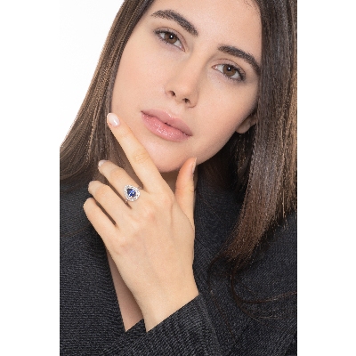 White gold 18k halo ring with pear cut blue sapphire and diamonds shoulder set