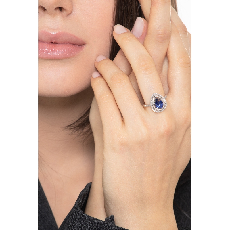 White gold 18k halo ring with pear cut blue sapphire and diamonds shoulder set