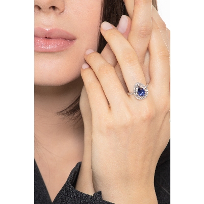 White gold 18k halo ring with pear cut blue sapphire and diamonds shoulder set