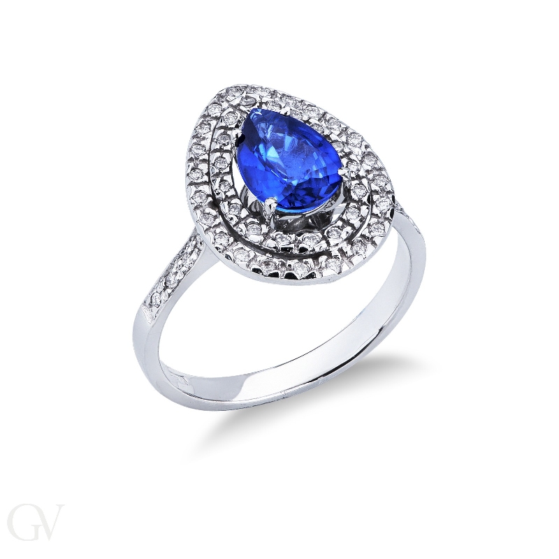 White gold 18k halo ring with pear cut blue sapphire and diamonds shoulder set