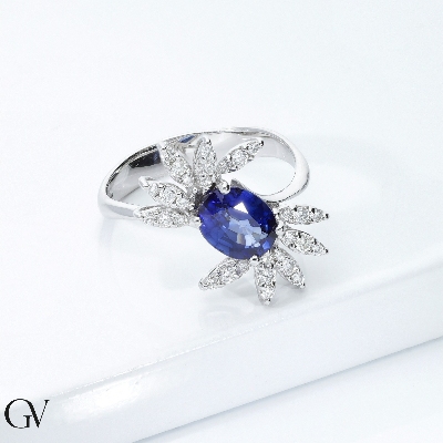 White gold 18k ring with a blue sapphire oval cut and diamonds petals  
