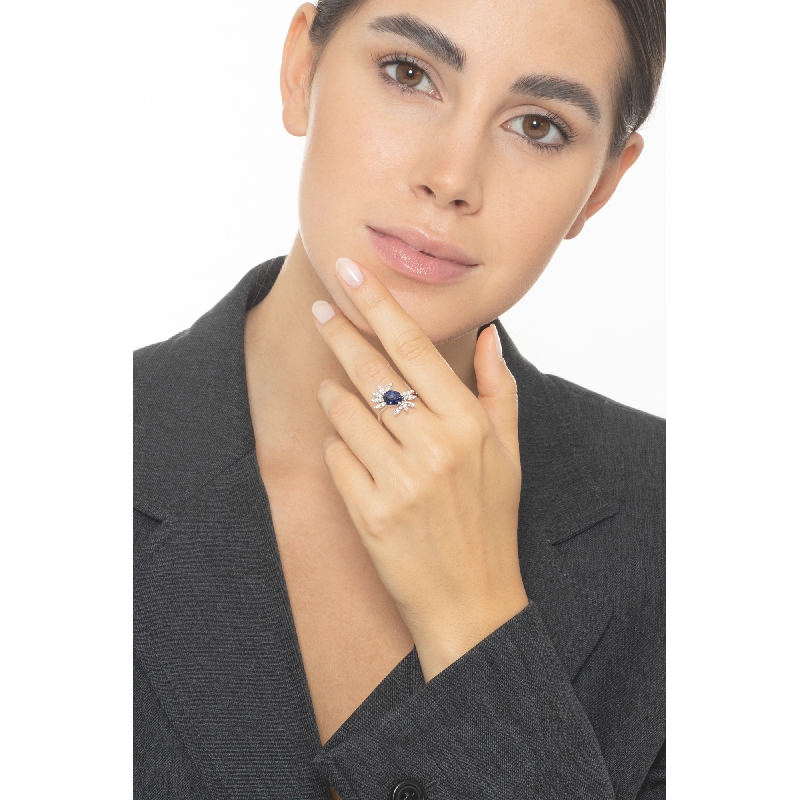 White gold 18k ring with a blue sapphire oval cut and diamonds petals  