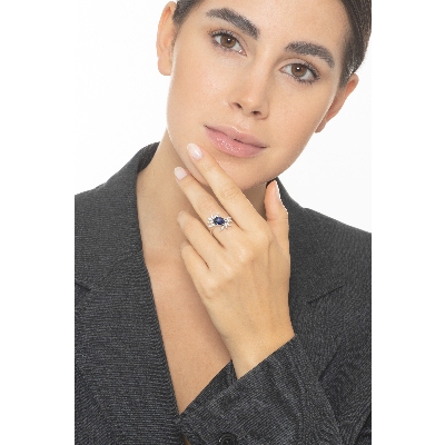 White gold 18k ring with a blue sapphire oval cut and diamonds petals  