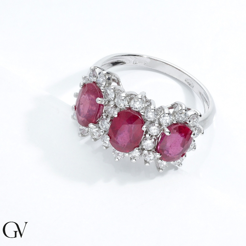 18k white gold halo ring with three rubies oval cut and diamonds 