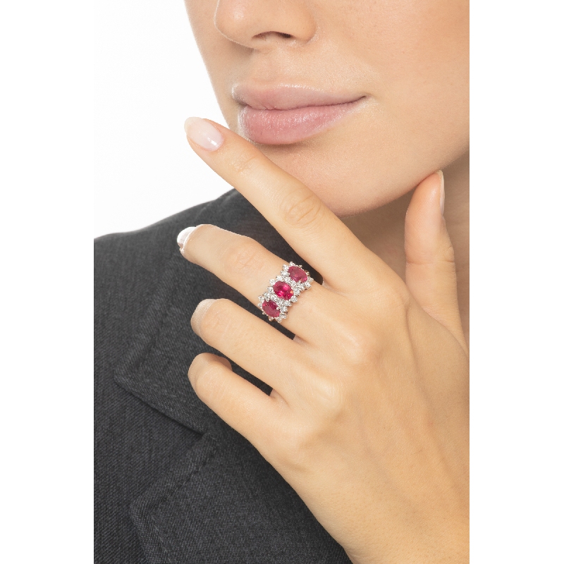 18k white gold halo ring with three rubies oval cut and diamonds 