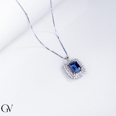Necklace with pendant, central emerald cut blue sapphire and round cut diamonds