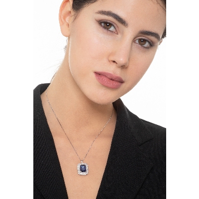 Necklace with pendant, central emerald cut blue sapphire and round cut diamonds