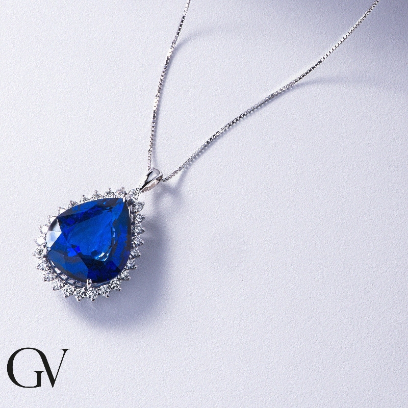 Necklace with pendant, pear cut blue sapphire and round cut diamonds