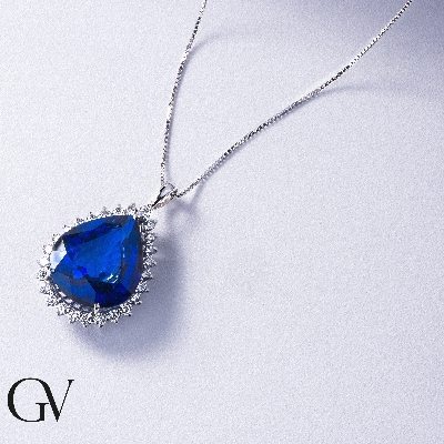 Necklace with pendant, pear cut blue sapphire and round cut diamonds