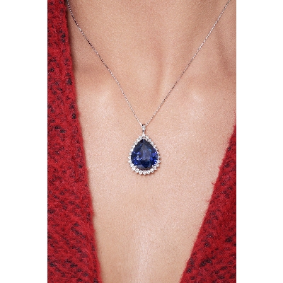 Necklace with pendant, pear cut blue sapphire and round cut diamonds