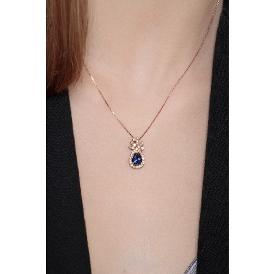 18k rose gold blue sapphire pendant with round cut diamonds
