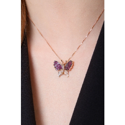 18k rose gold butterfly pendant with rubies and round cut diamonds