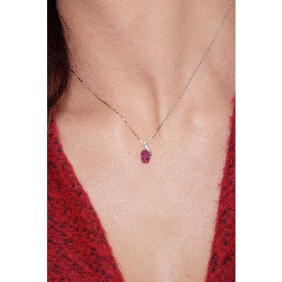 Fancy ruby pendant with round cut diamonds
