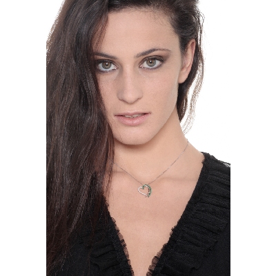 Heart shape pendant with diamonds and a row of emeralds