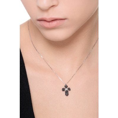 Rounded cross pendant with black diamonds and a solitaire diamond