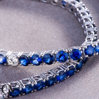 Wire style tennis bracelet with sapphires and round cut diamonds