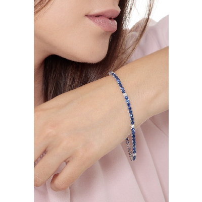Wire style tennis bracelet with sapphires and round cut diamonds
