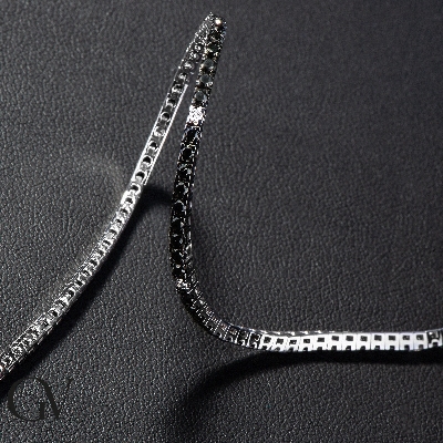 18k white gold tennis bracelet with black and white diamonds and burnished tips