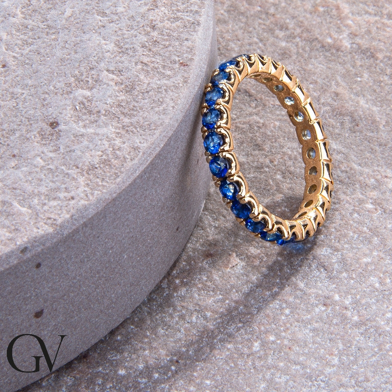 Eternity ring with blue sapphires in yellow gold 18k