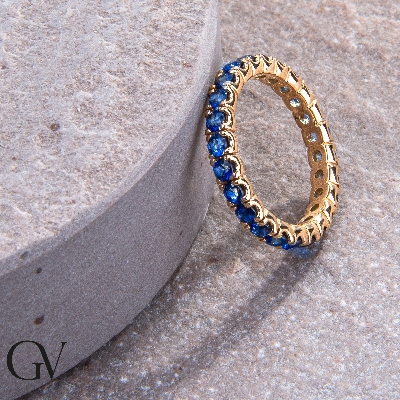 Eternity ring with blue sapphires in yellow gold 18k
