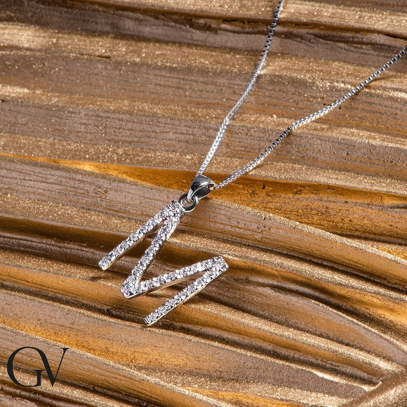 Letter M pendant with round cut diamonds