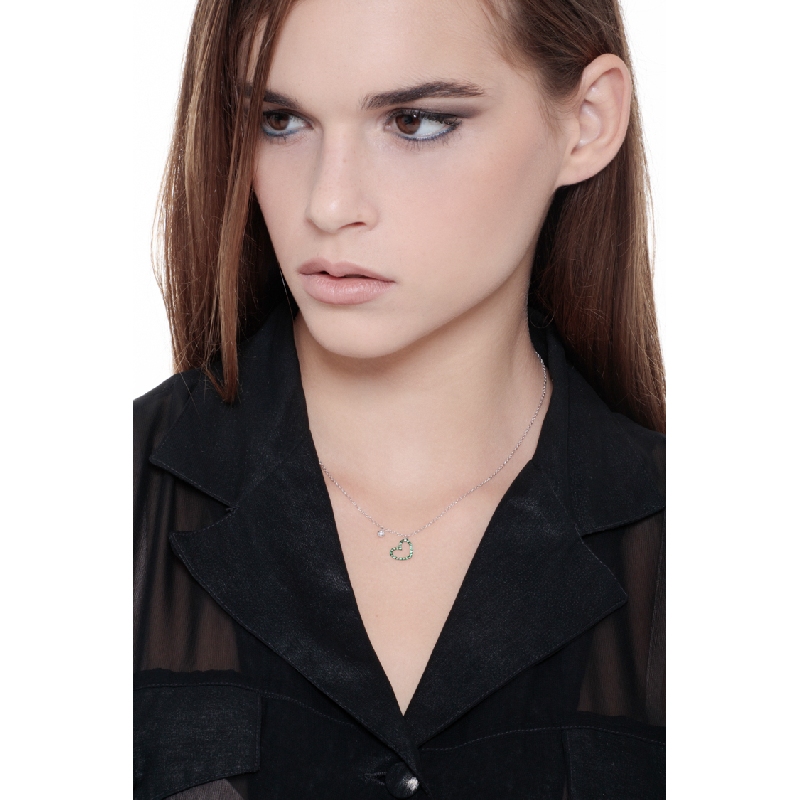 Necklace with burnished heart pendant with emeralds and a solitaire diamond