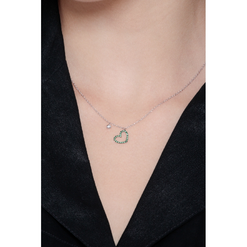 Necklace with burnished heart pendant with emeralds and a solitaire diamond