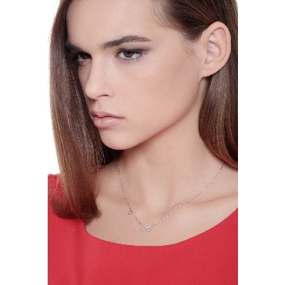 Infinity symbol pendant with diamonds and a single round cut diamond