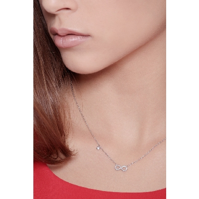 Infinity symbol pendant with diamonds and a single round cut diamond