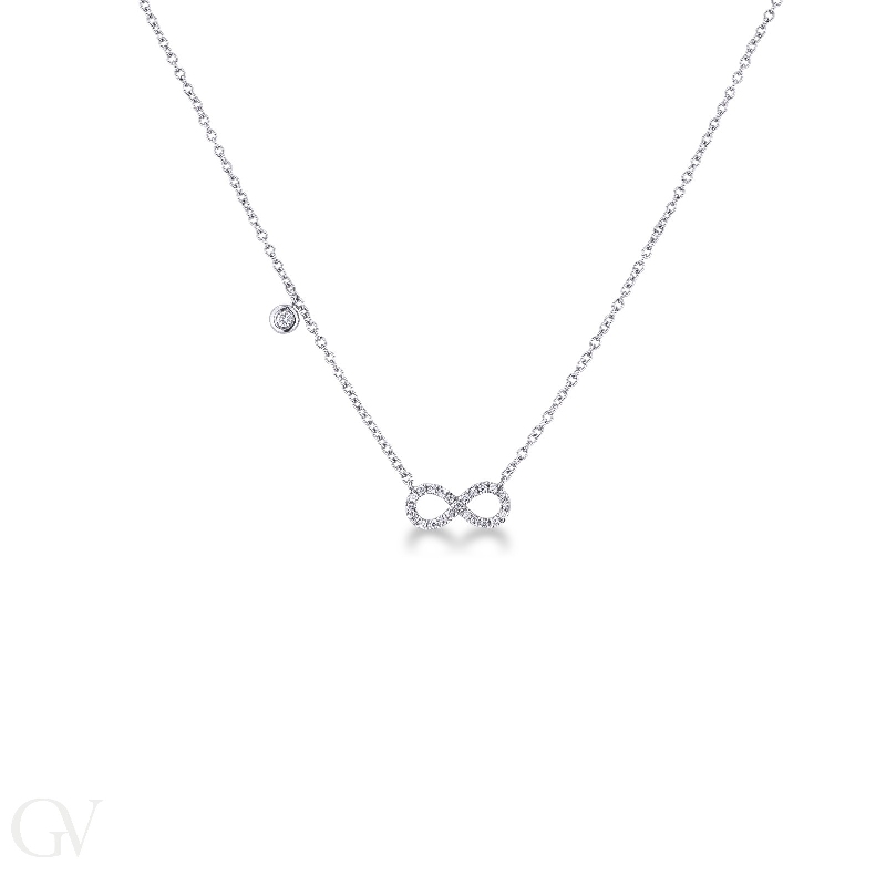 Infinity symbol pendant with diamonds and a single round cut diamond