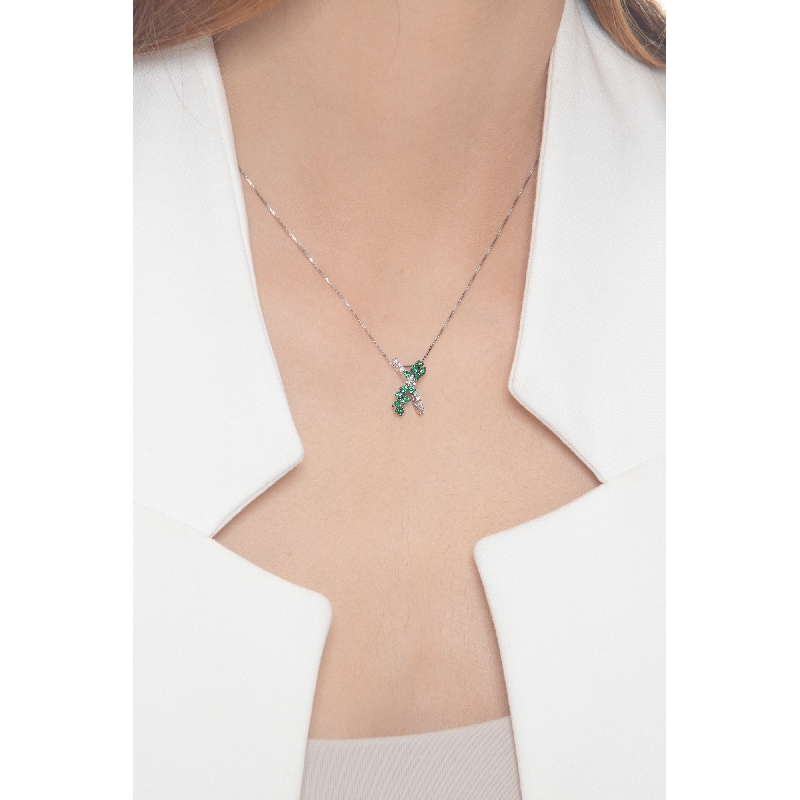 Necklace with fancy twisted pendant with emeralds and diamonds