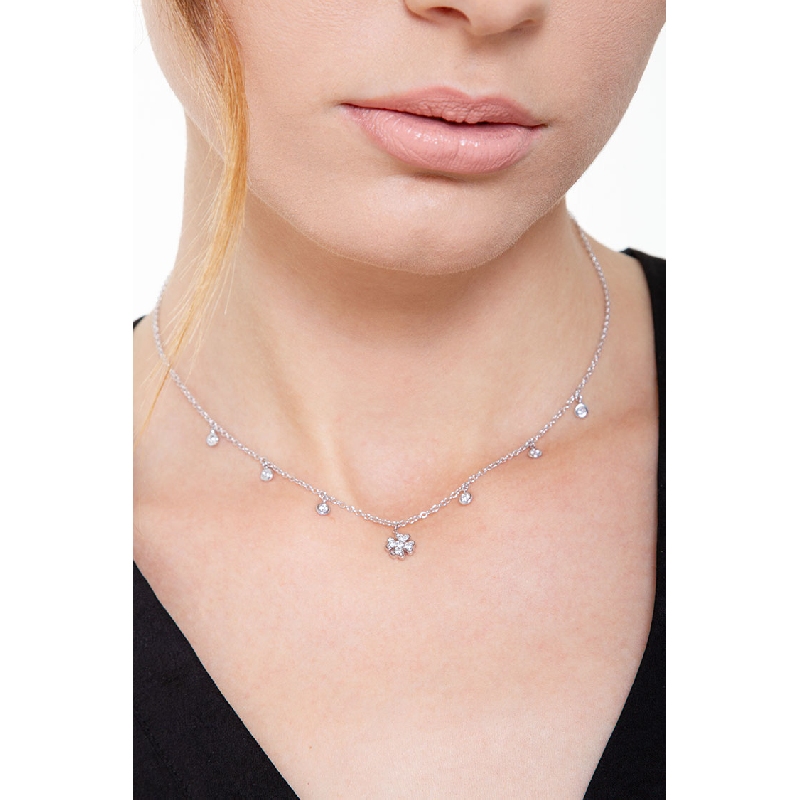 Necklace with 6 round cut diamonds and a four leaf clover pendant 