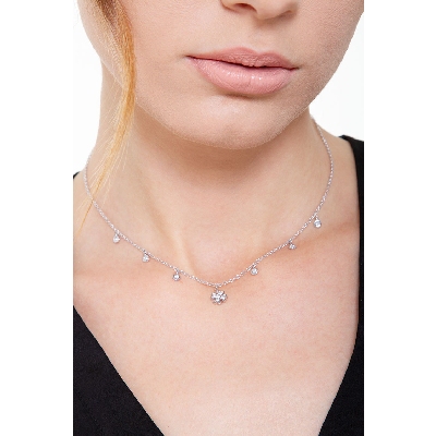 Necklace with 6 round cut diamonds and a four leaf clover pendant 